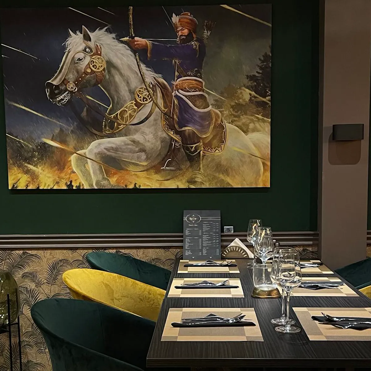 The painting of the Sikh warrior above a set table