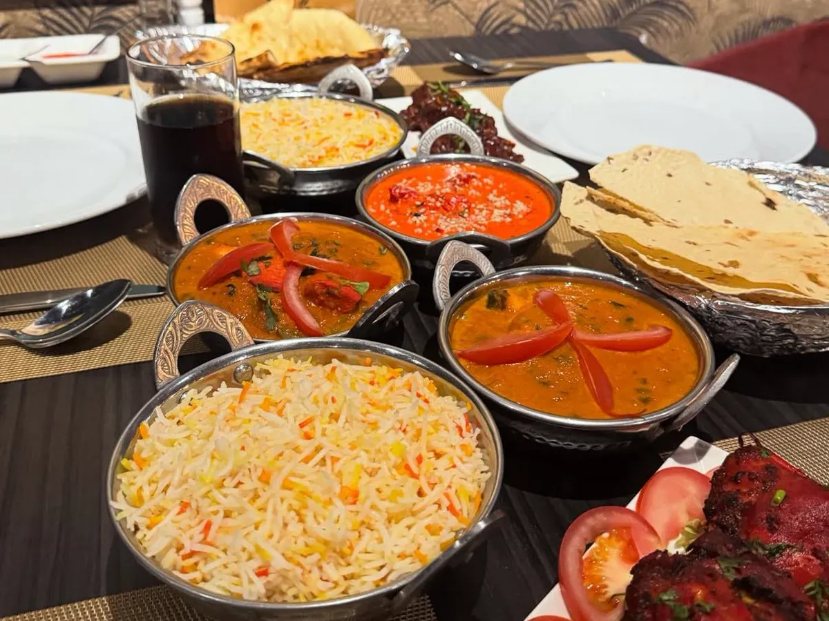 A full table: rice, curries, naan and tandoori