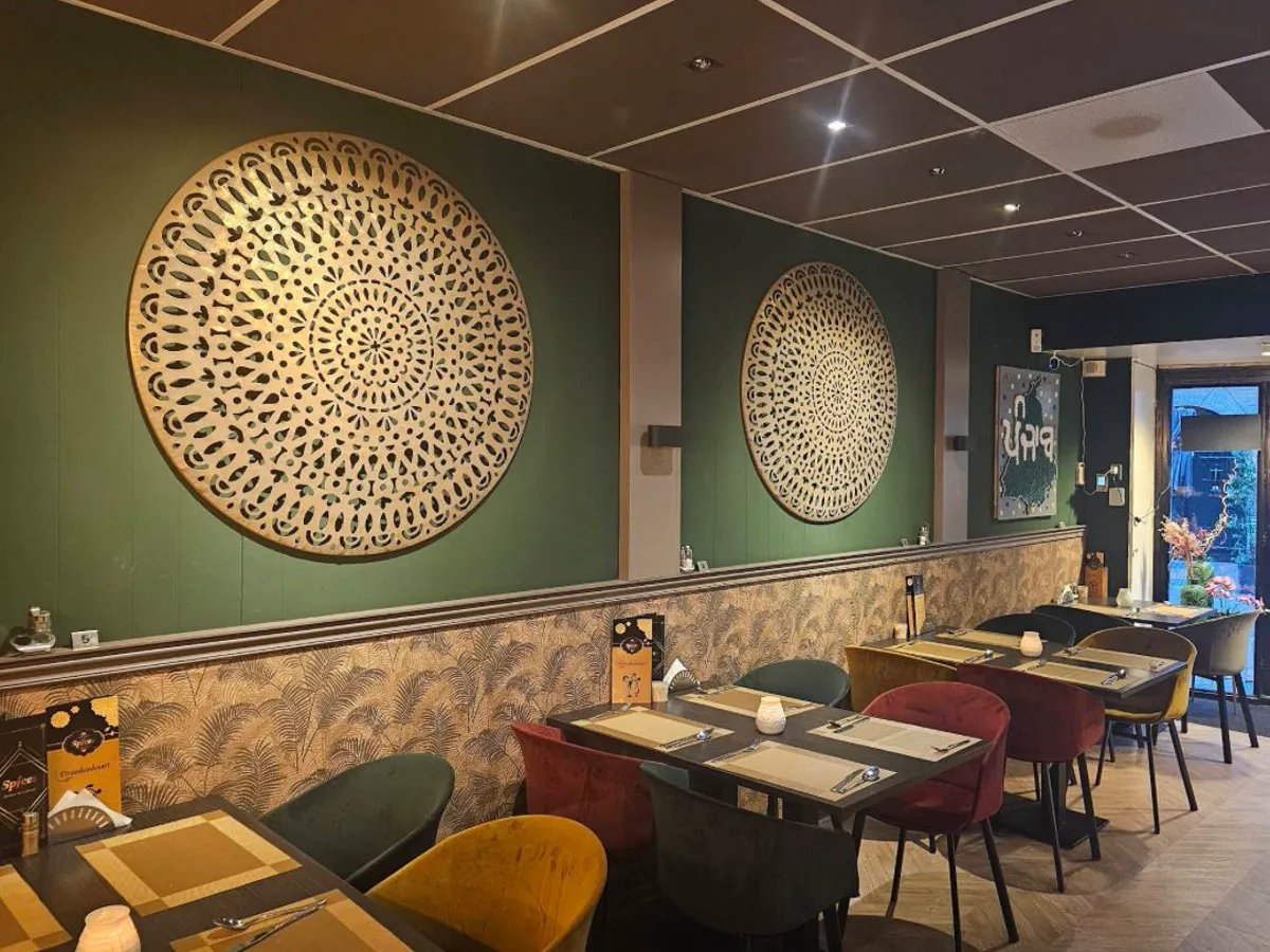 Golden wall decoration above the tables