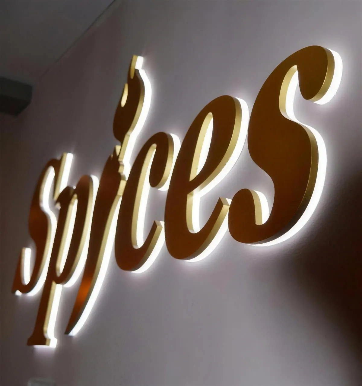 The golden Spices logo on the restaurant wall